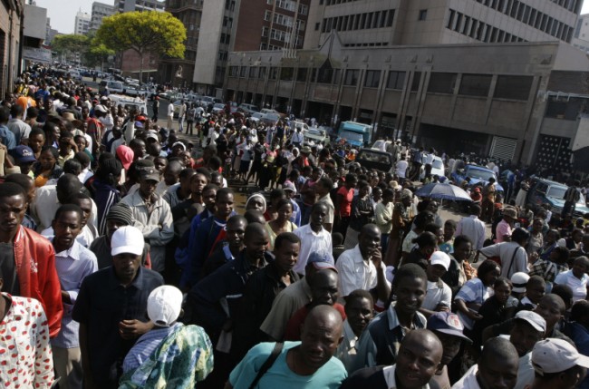 Hundreds of people queue up to get  money from the  banks in Harare, Tuesday, Sept.  30, 2008. Zimbabwe bank authorities raised the daily withdrawal limit prompting tens of thousands of  depositors to line up in hopes of getting enough cash for groceries before spiraling inflation eats away more value in  a country with the worlds highest inflation rate . (AP Photo/Tsvangirayi Mukwazhi)